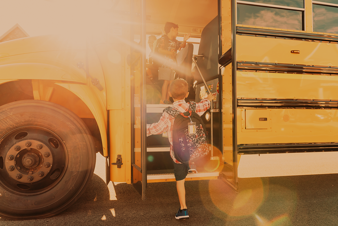 Boy walking onto school bus