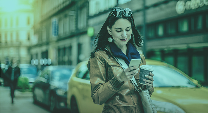 Lady drinking coffee looking at phone