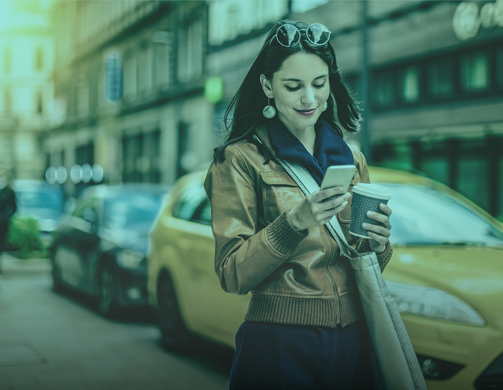 Lady drinking coffee looking at phone